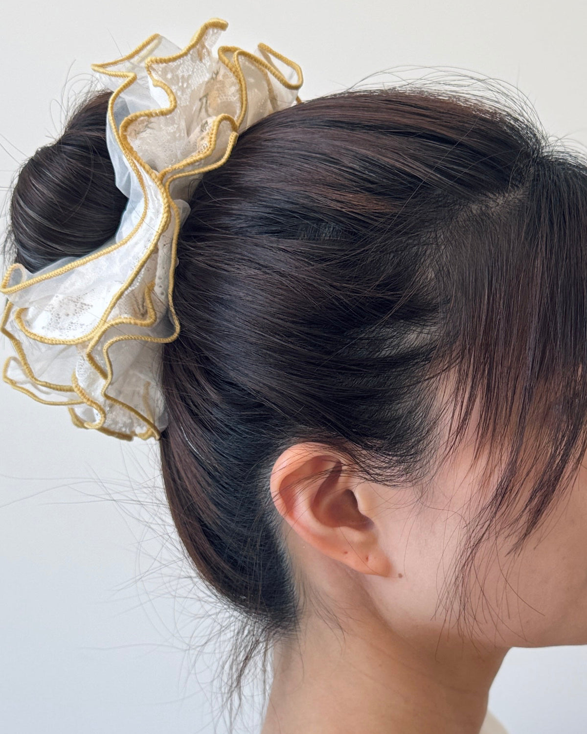 Yellow floral lace scrunchie worn in long hair